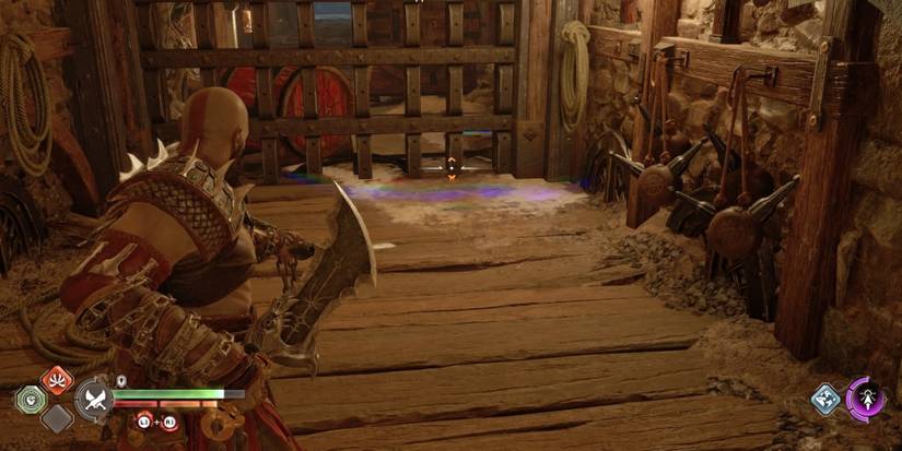 Kratos aims the Blades of Chaos at an oil spill in God of War Ragnarok