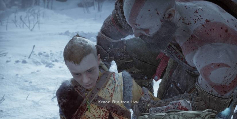 Kratos cradles Atreus in God of War: Ragnarok