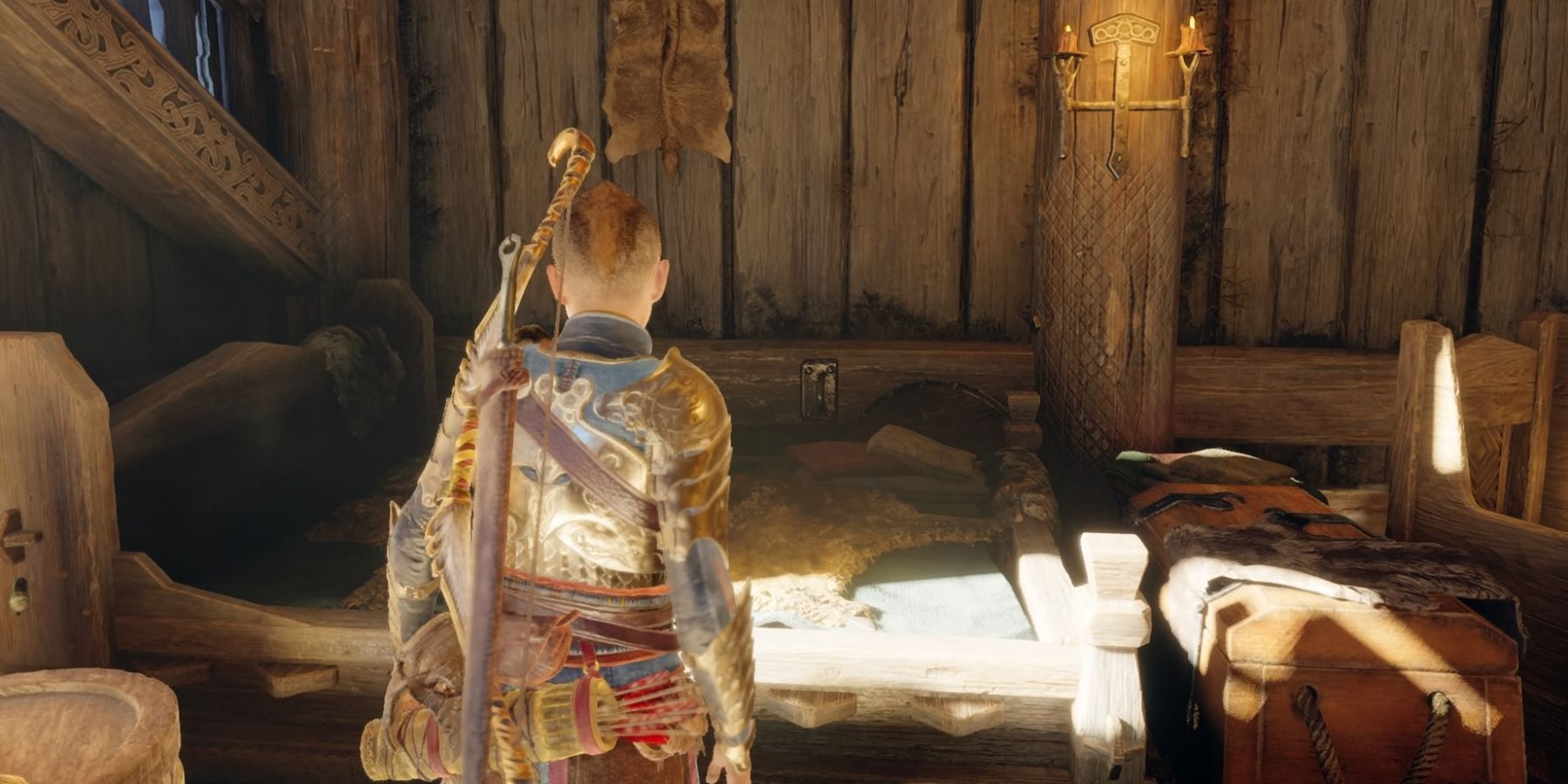 Atreus stands beside his bed in God of War Ragnarok