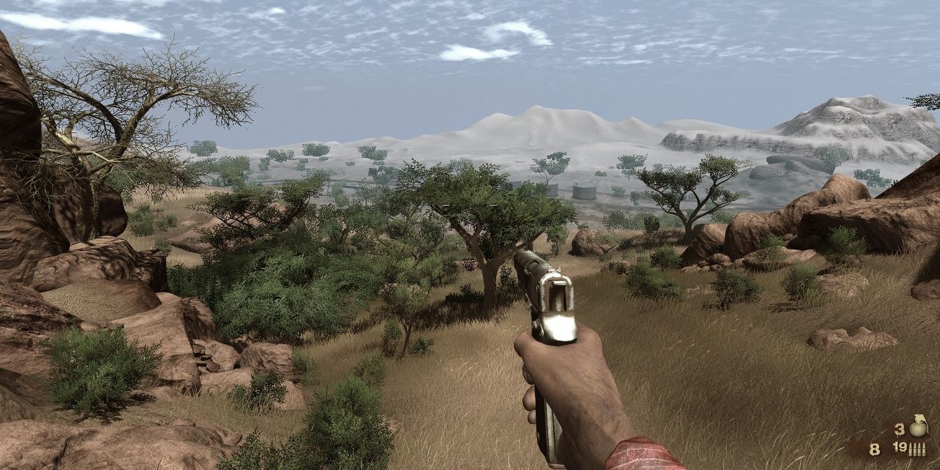 Far Cry 2 holding a pistol walking in a field