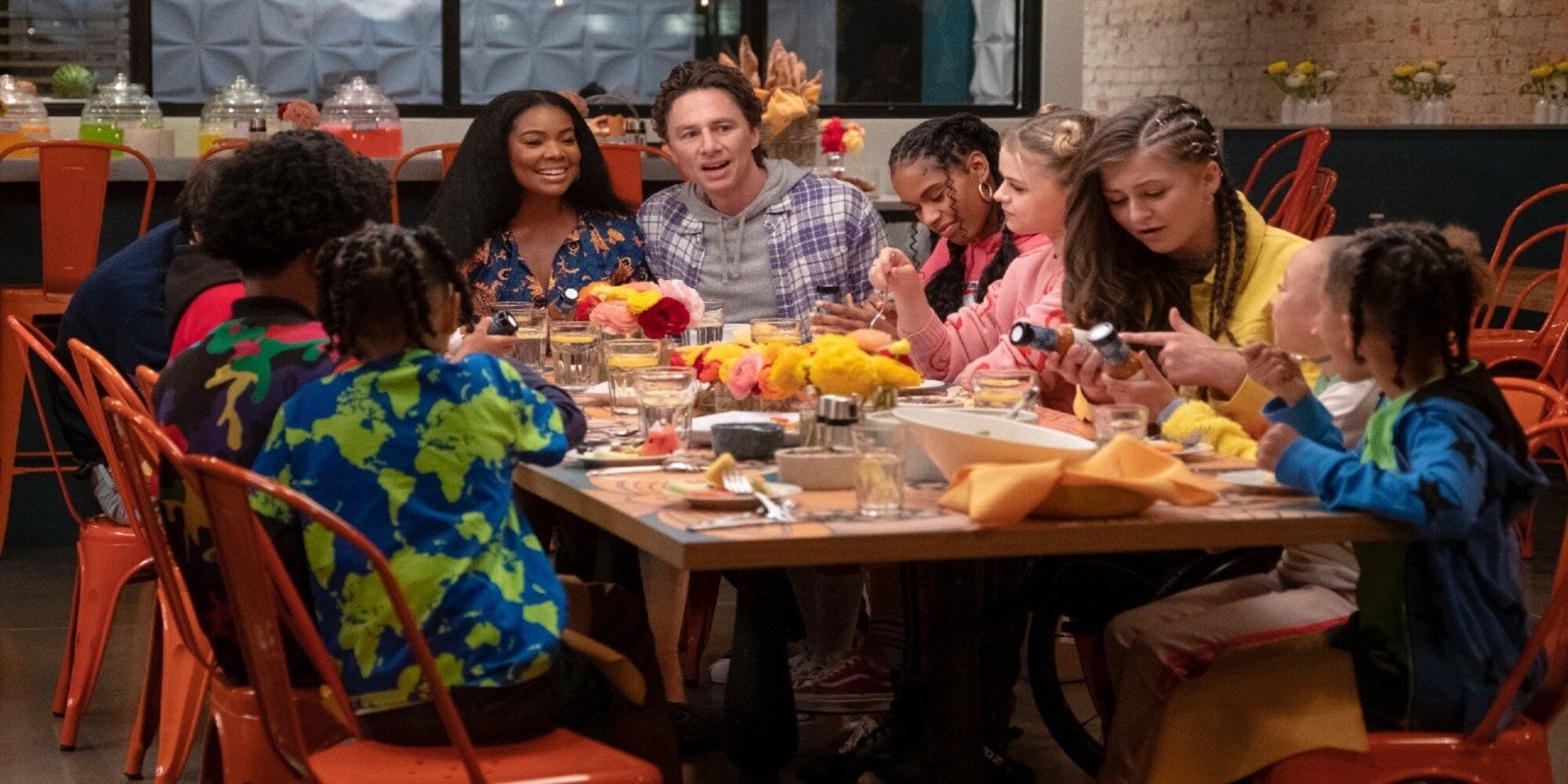 The 2022 Reboot Baker Family Sat at for a meal together looking happy