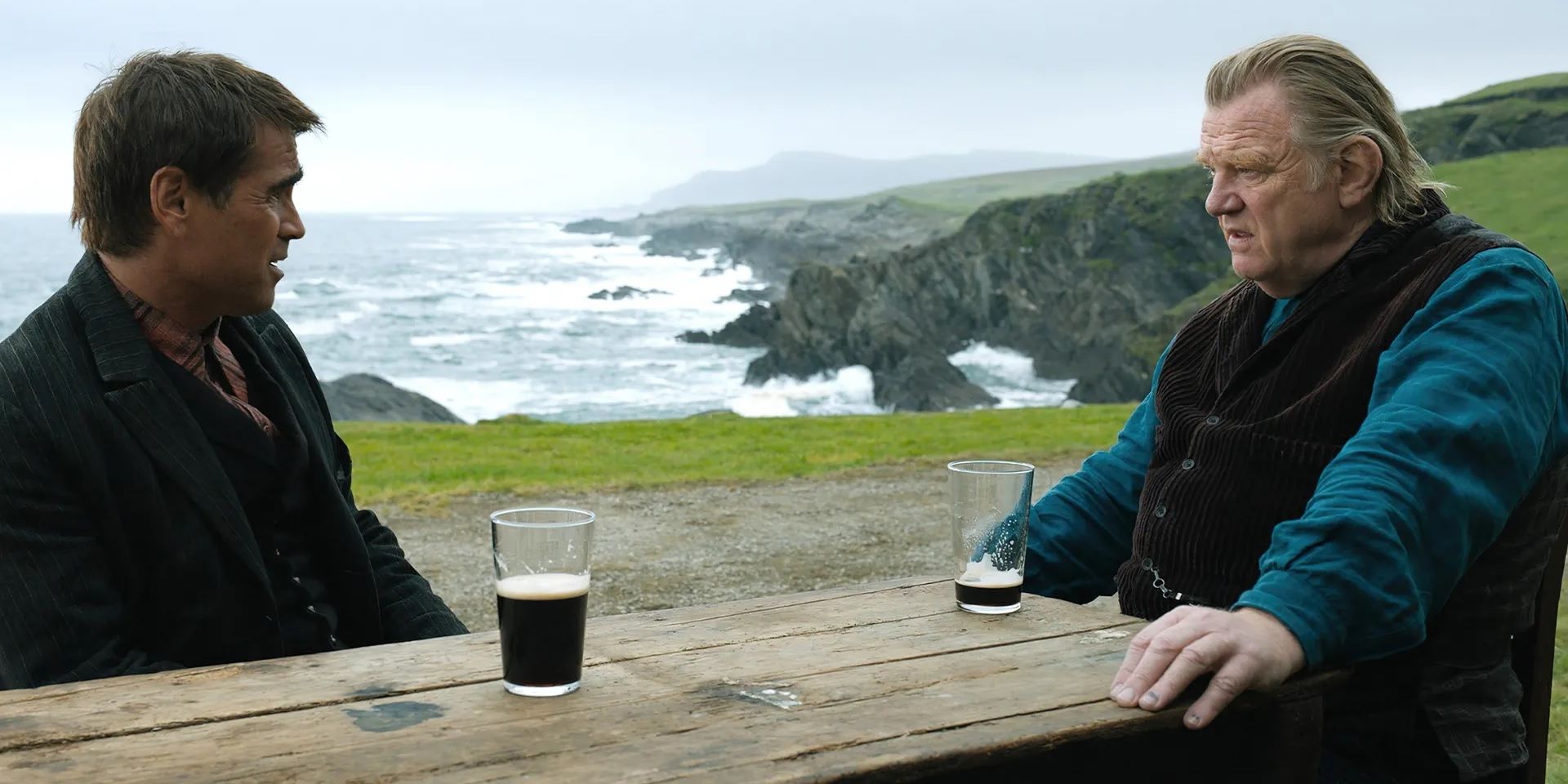 Colin Farrell and Brendan Gleeson sitting at a pub in The Banshees of Inisherin