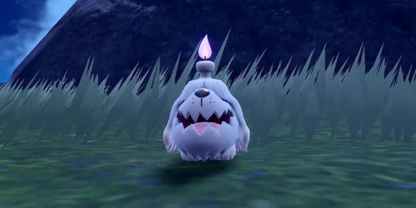 Greavard standing in front of tall grass in Pokemon Scarlet and Violet