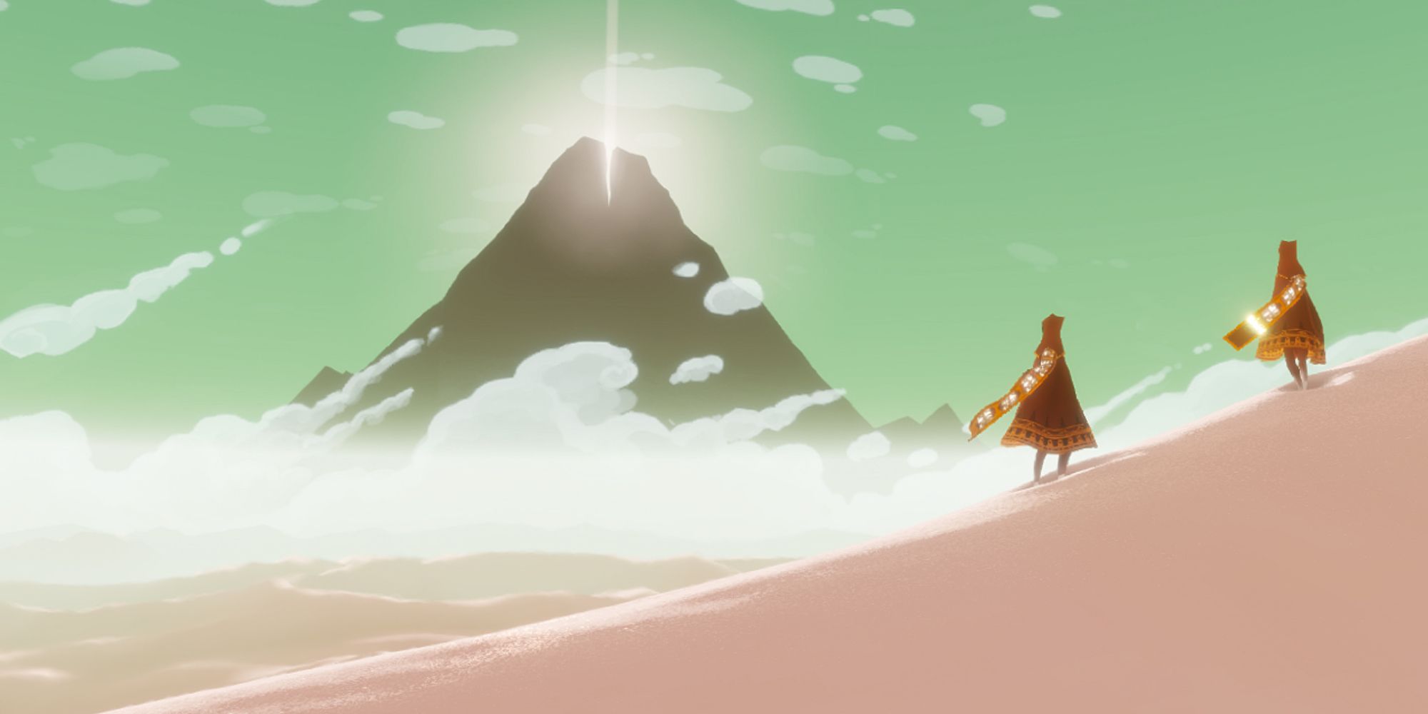 Two figures clad in red (right) stand on a sand dune while looking at a distant mountain with a light emanating from its peak.