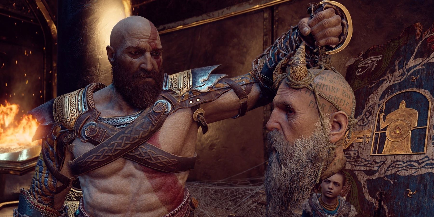 Kratos holding Mimir's head in God of War with Atreus in background