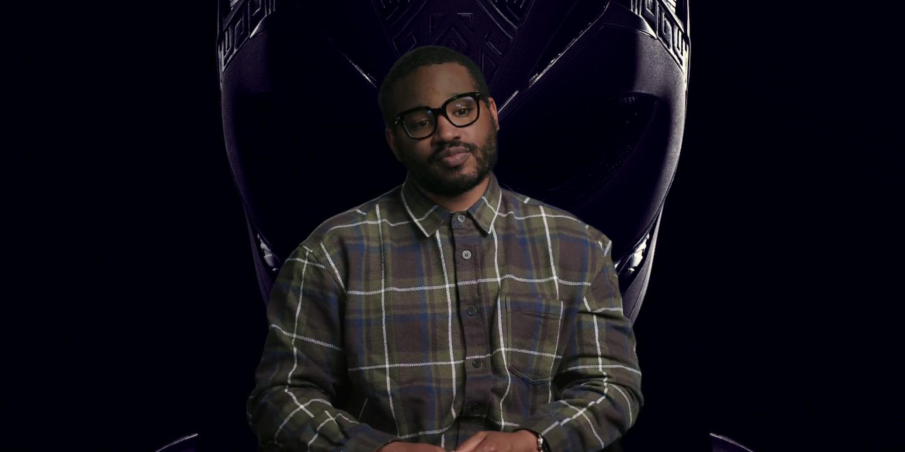 Ryan Coogler with Black Panther: Wakanda Forever poster background