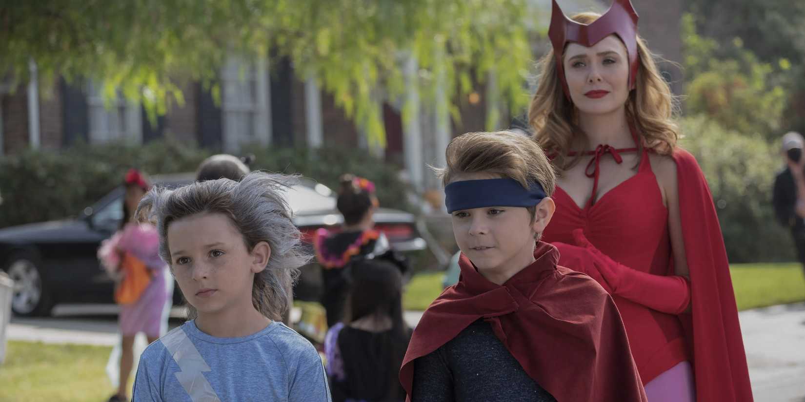Billy and Tommy dressed for Halloween as Wanda follows them