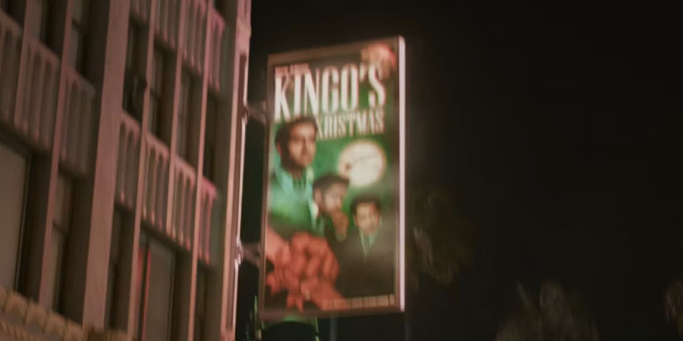 A poster for a Kingo Christmas movie on a building in the Guardians of the Galaxy Holiday Special