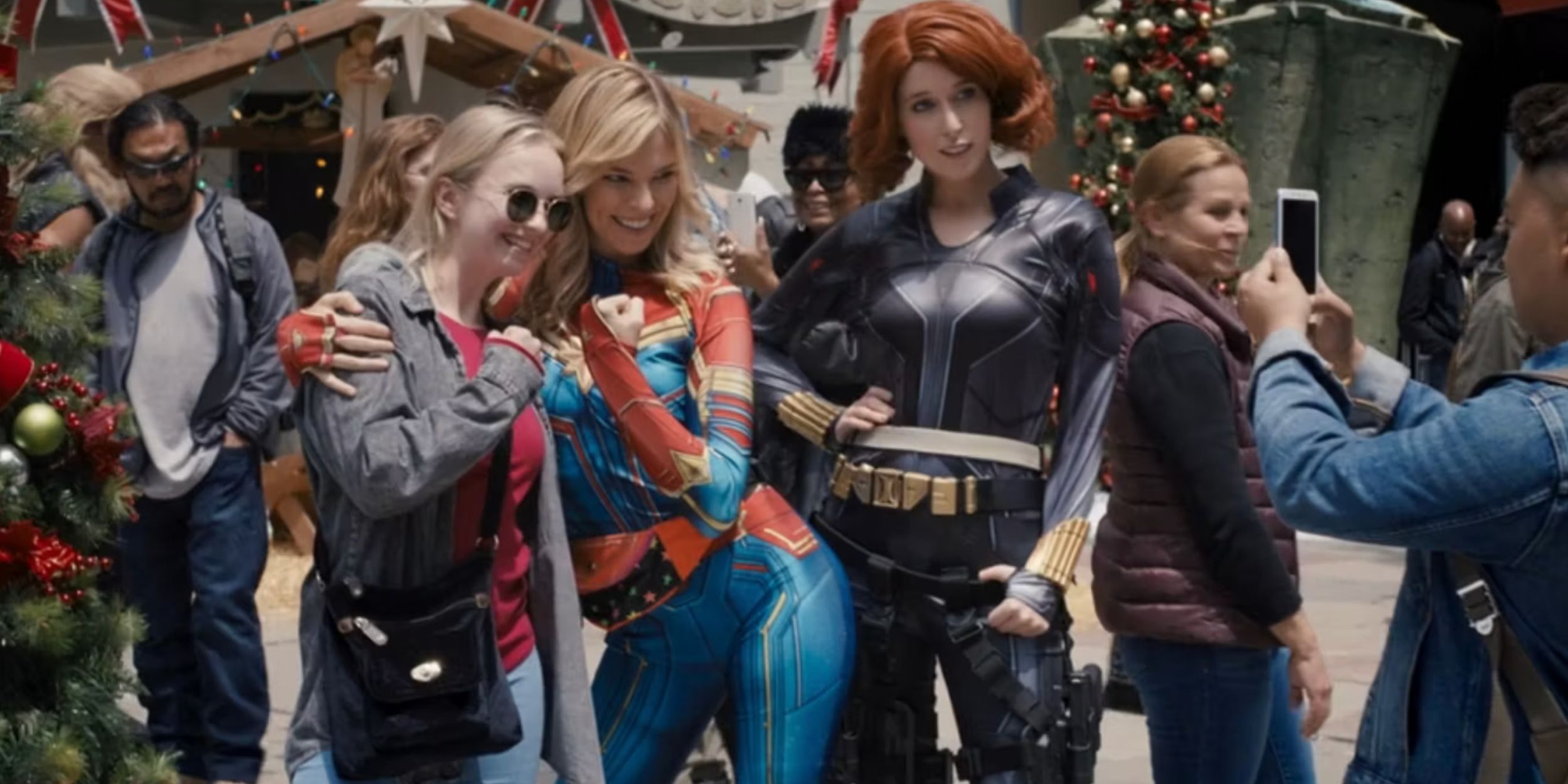 Captain Marvel and Black Widow character actors pose with fans for pictures in Guardians of the Galaxy Holiday Special