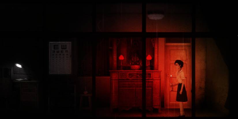 Ray holding a candle in front of a shrine that acts as a save point