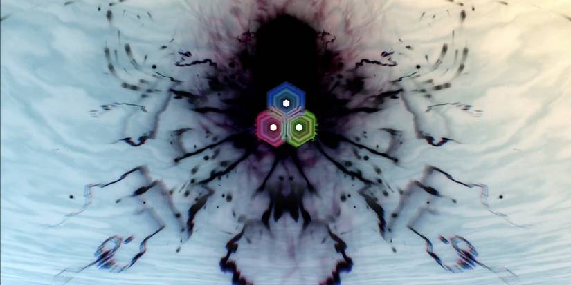 a picture of some squid monster with 3 eyes emanating green, red, and blue lights.