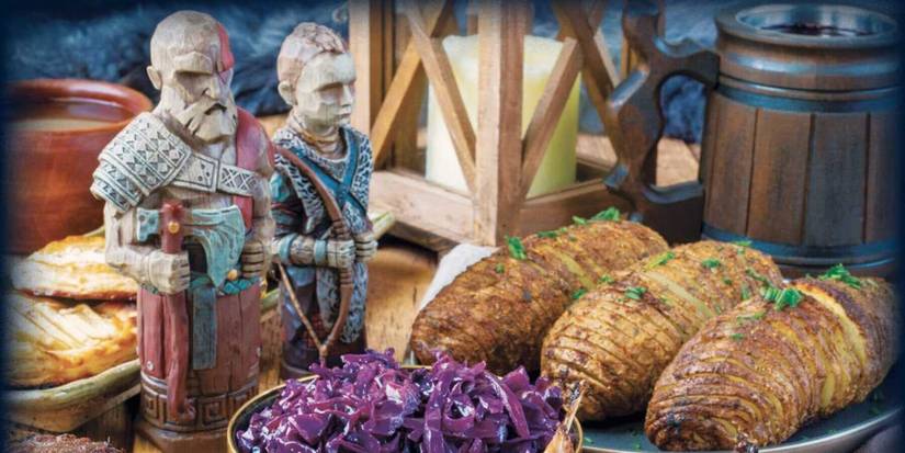 cover of god of war the official cookbook of the nine realms featuring figurines of Kratos and Atreus in front of various meals