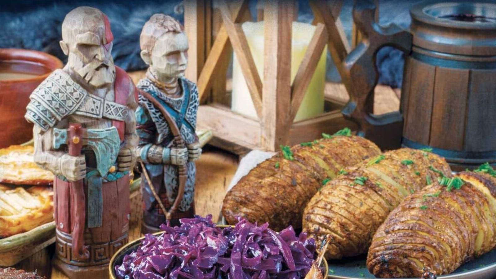 cover of god of war the official cookbook of the nine realms featuring figurines of Kratos and Atreus in front of various meals