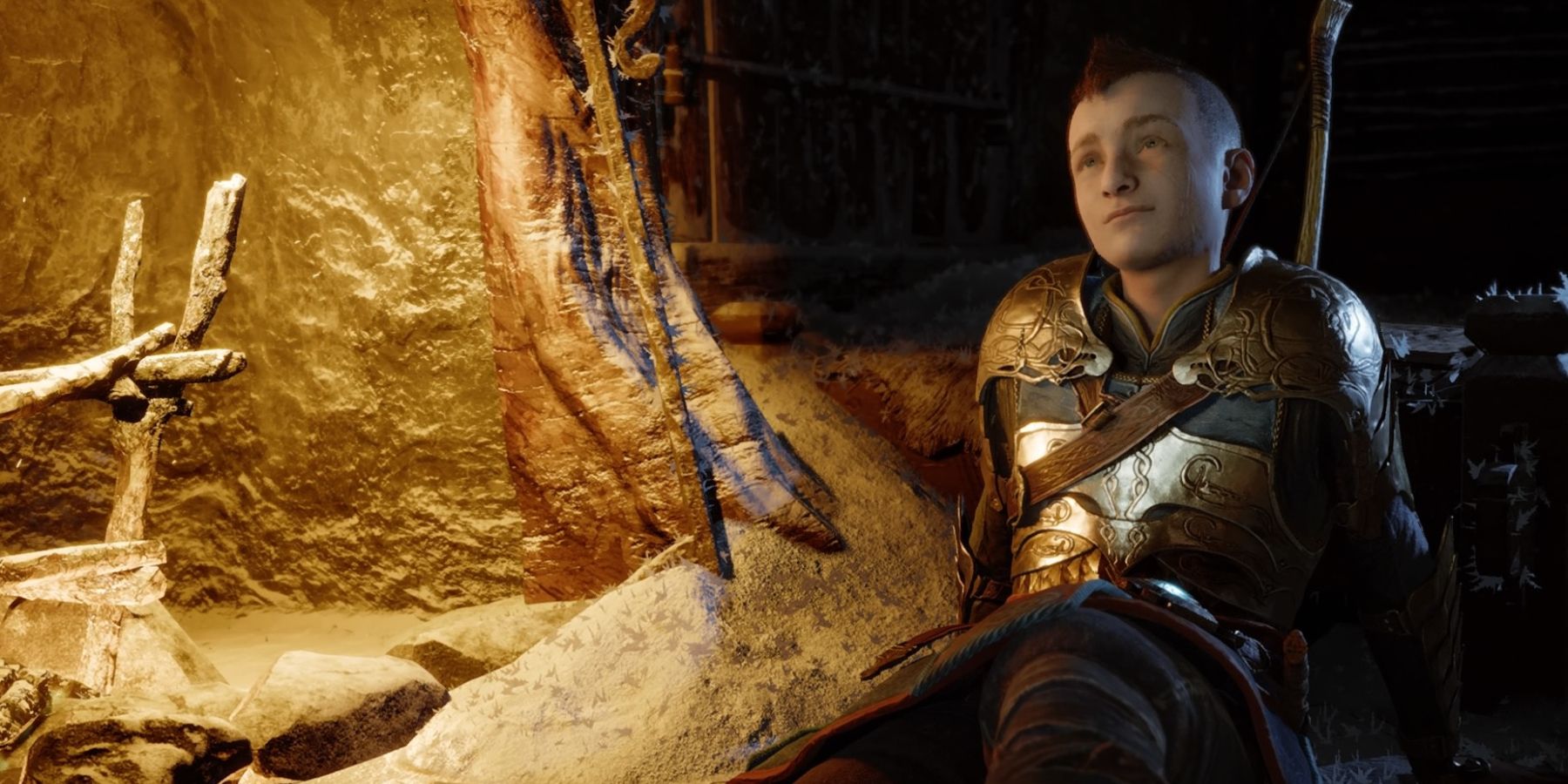 Atreus sits beside a fireplace in God of War Ragnarok