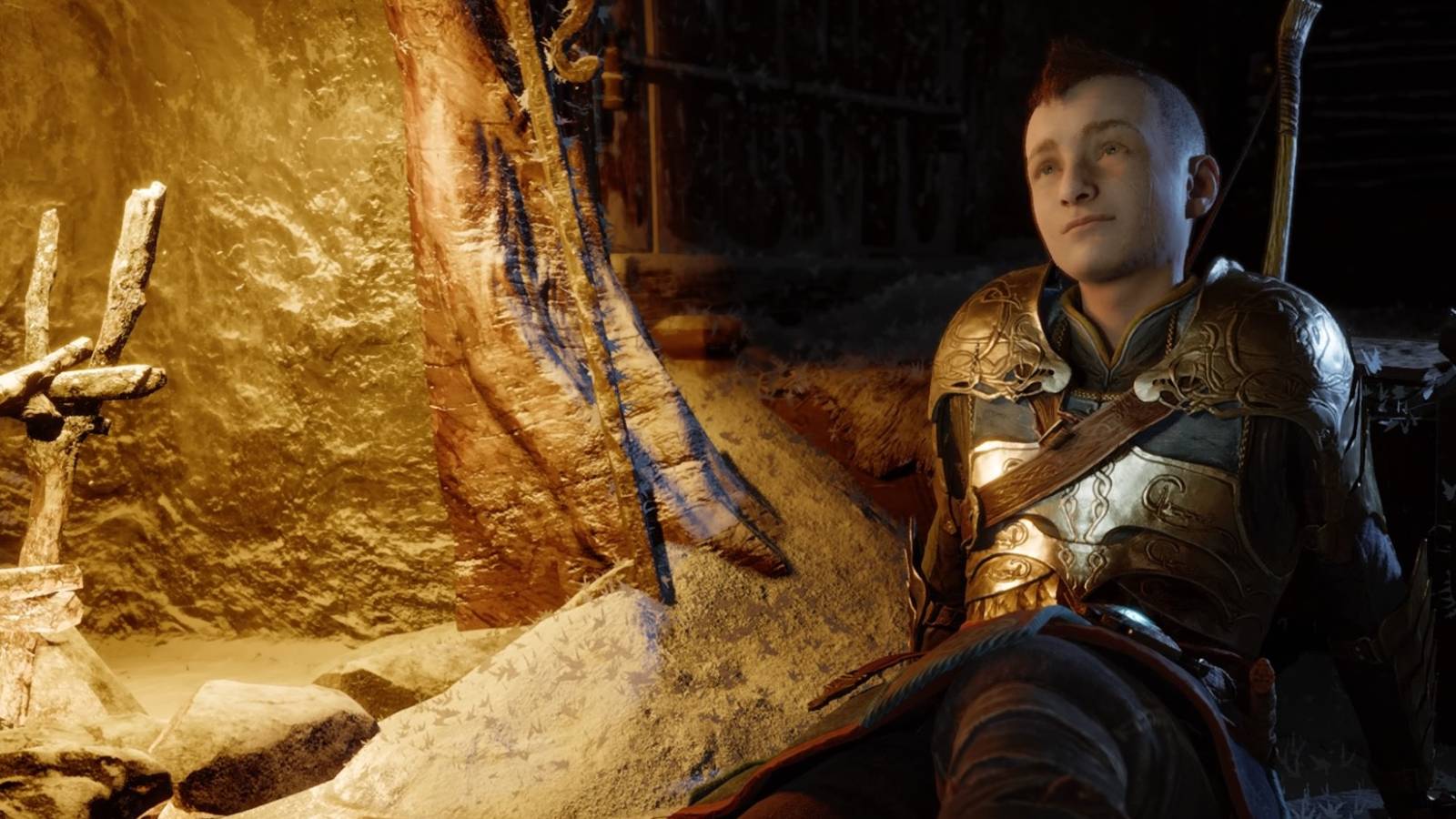 Atreus sits beside a fireplace in God of War Ragnarok
