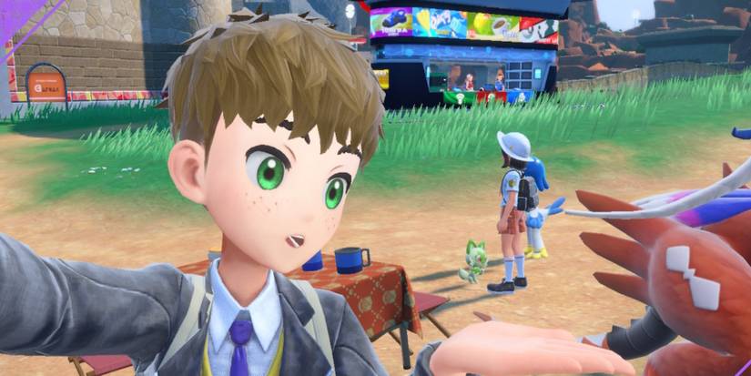 a couple picnicking with their pokemon 