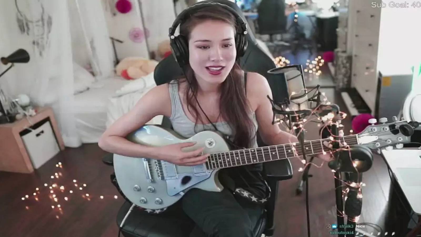 Twitch Streamer Indieefoxx holding a guitar