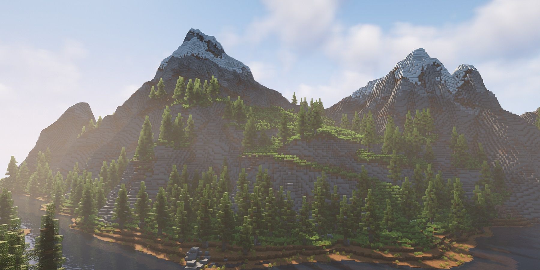 Screenshot from Minecraft showing some mountains in the distance lit by the sunlight.