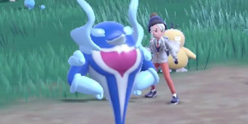 Palafin in its hero form next to its trainer and a Psyduck