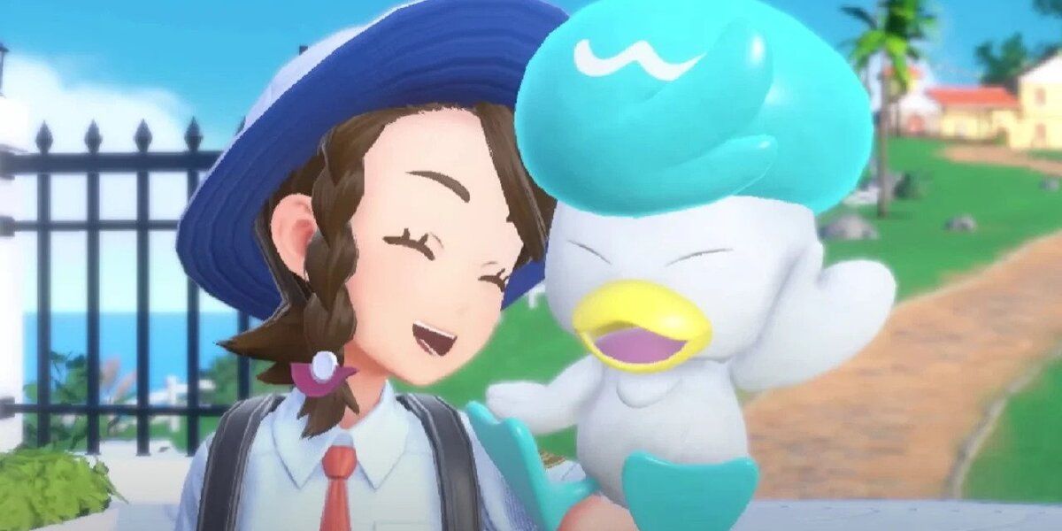 The player smiling and holding Quaxly in Pokemon Scarlet and Violet