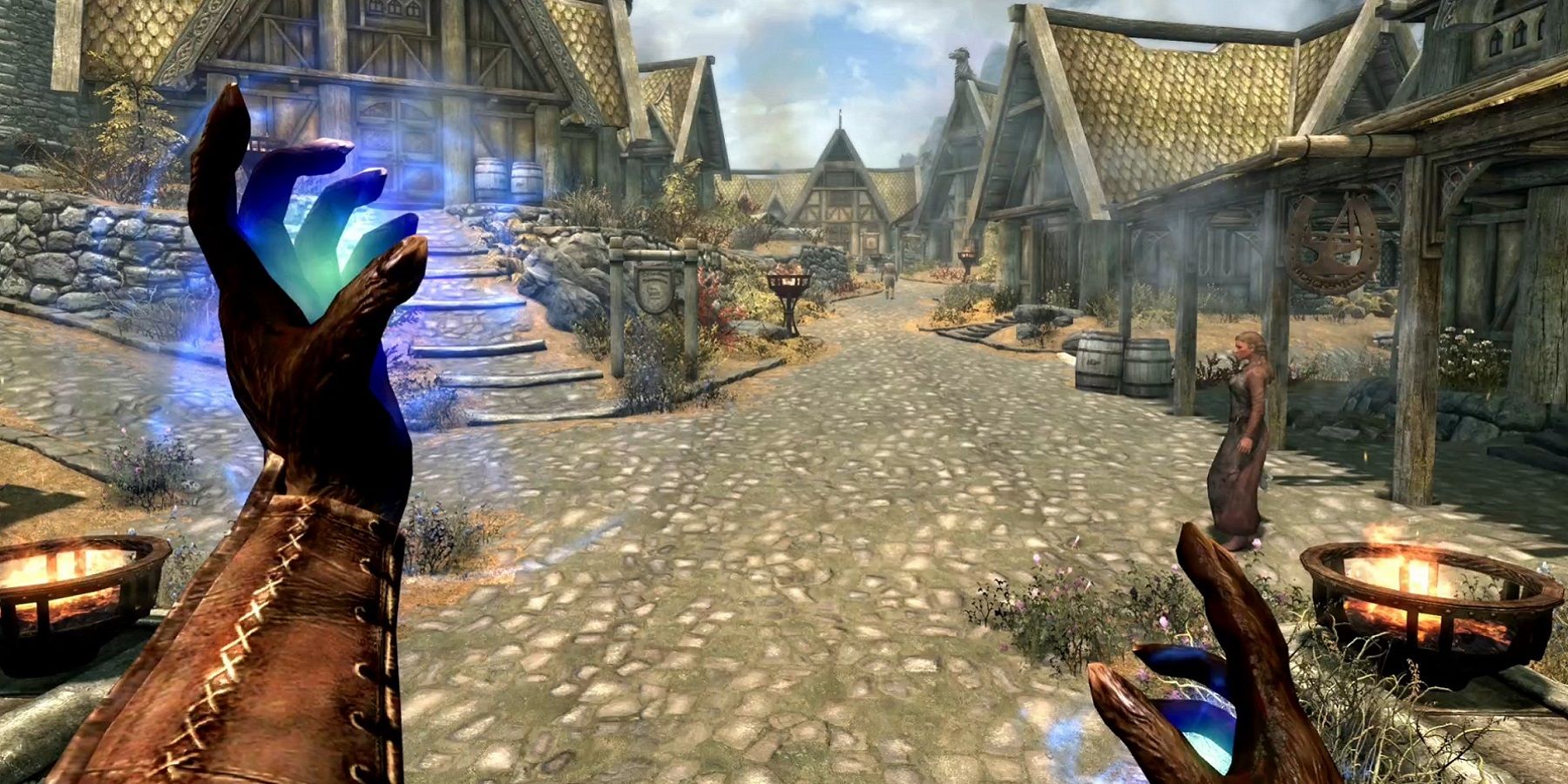 Image from Skyrim showing the player readying some magic in the city of Whiterun.