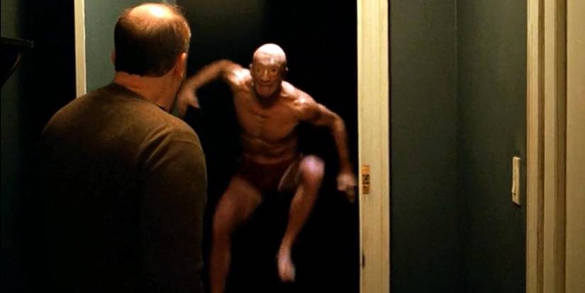 A_man_jumps_out_of_the_darkness_in_a_nightmare_in_Louie