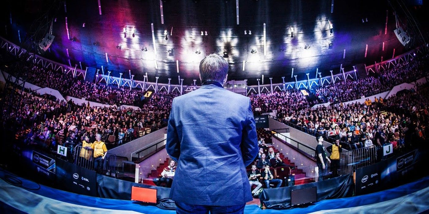 All Work All Play documentary wide shot of host looking on at crowd at esports arena