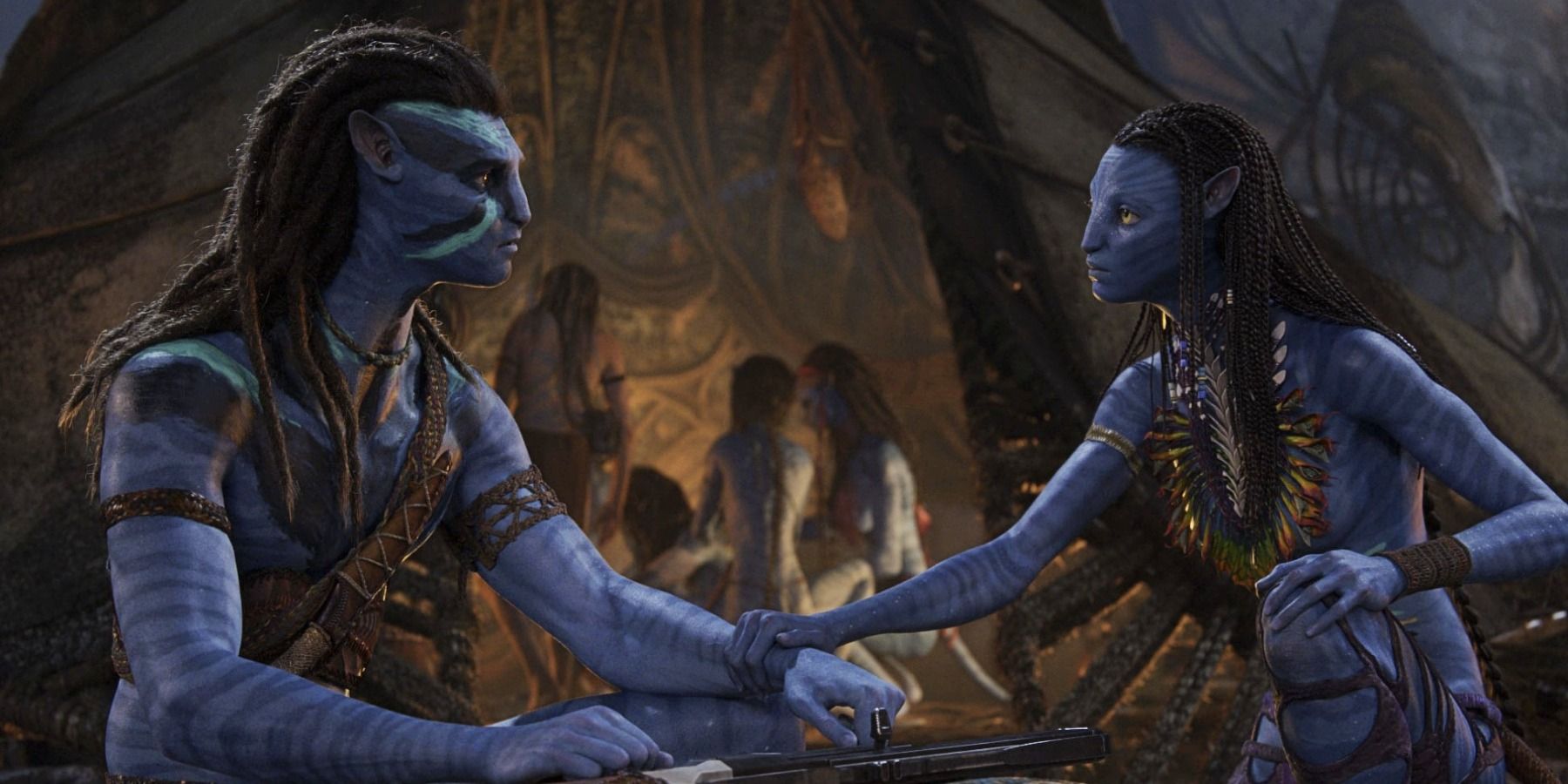 Avatar: The Way of Water Jake Sully and Neytiri holding hands in campfire