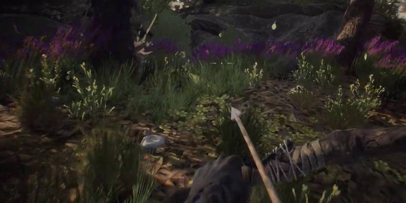 Player uses bow and arrow to defend herself in the wild