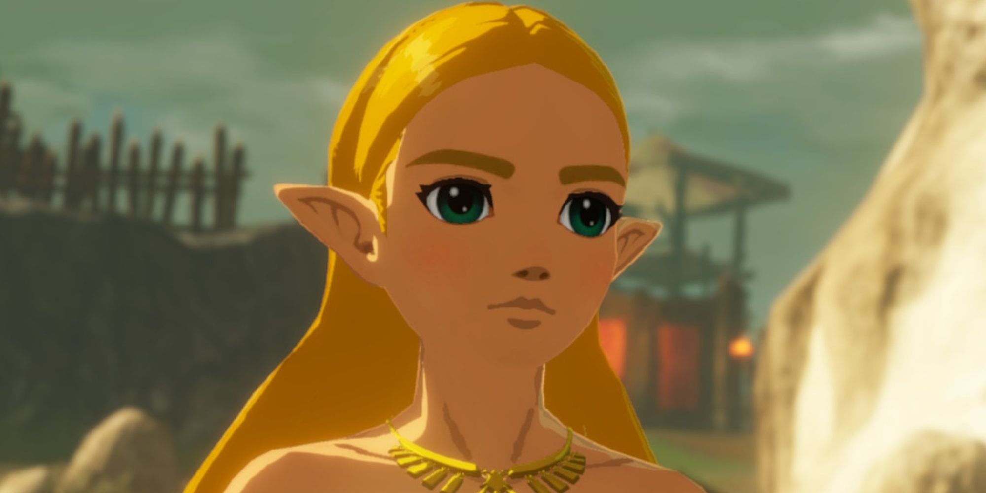 Close-up of the blonde titular Princess with a determined expression on her face, glimpses of what appear to be a stronghold behind her.