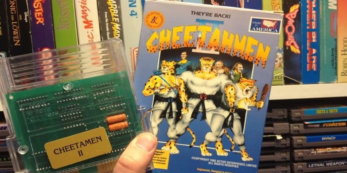 holding Cheetahmen 2 NES cart and box art