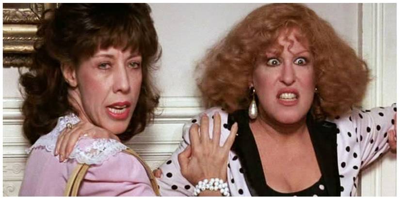 Lily Tomlin and Bette Midler starring in Big Business looking scared and leaning against a door