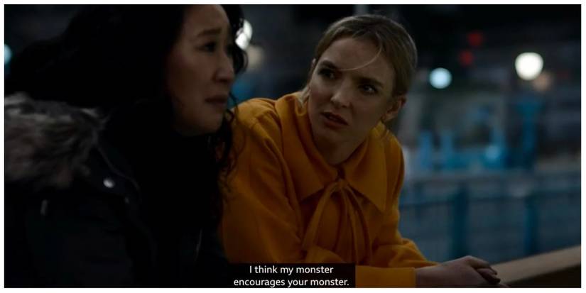 Eve (left) and Villanelle stood leaning on a bridge over the River Thames having a conversation