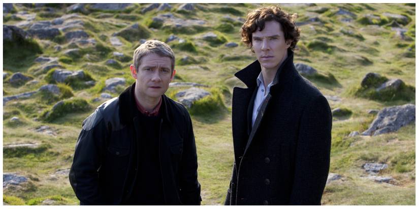 John Watson (left) and Sherlock stood together looking up at something offscreen
