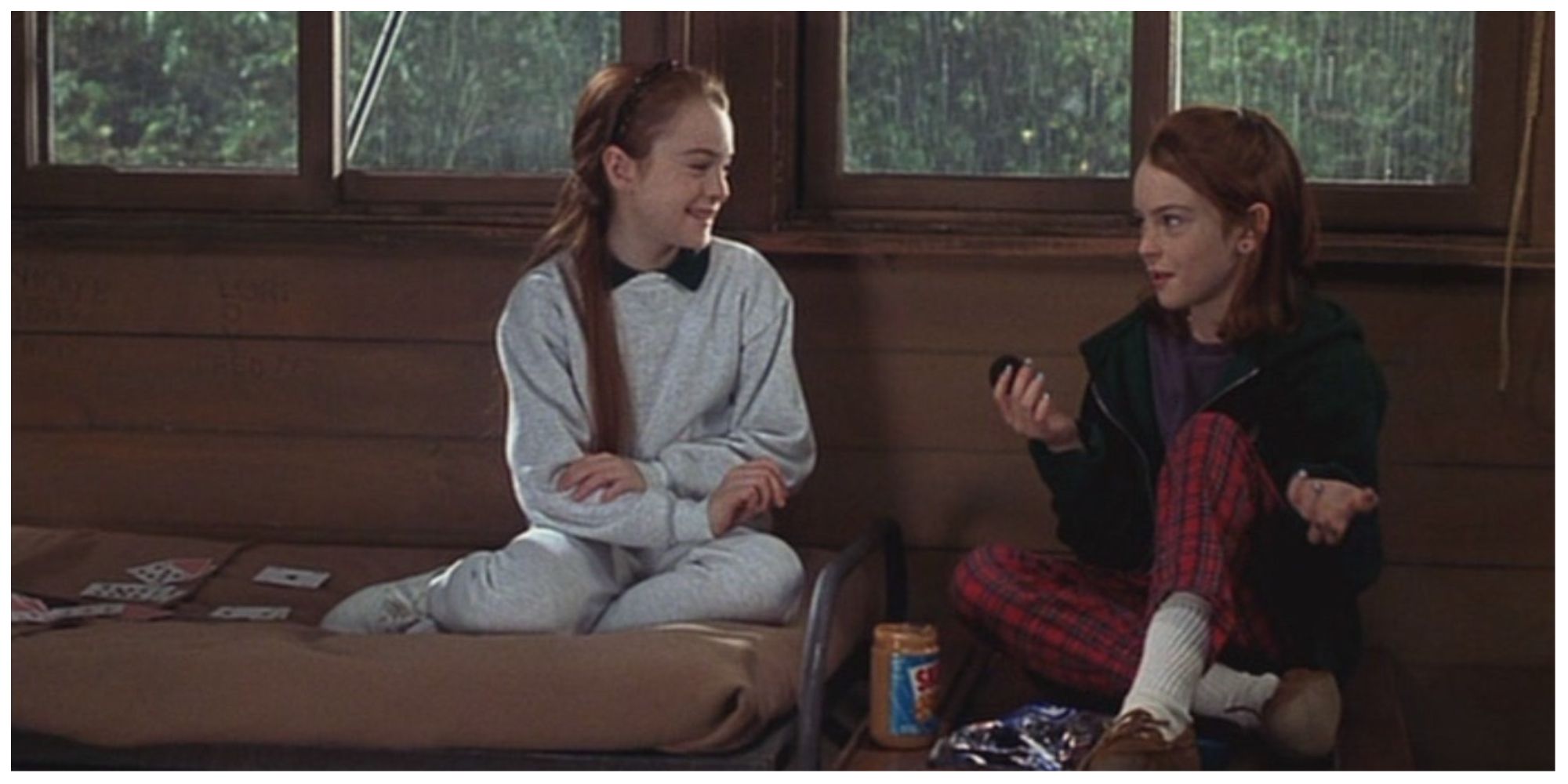 Annie and Hallie sat in their camp dormitory laughing and bonding