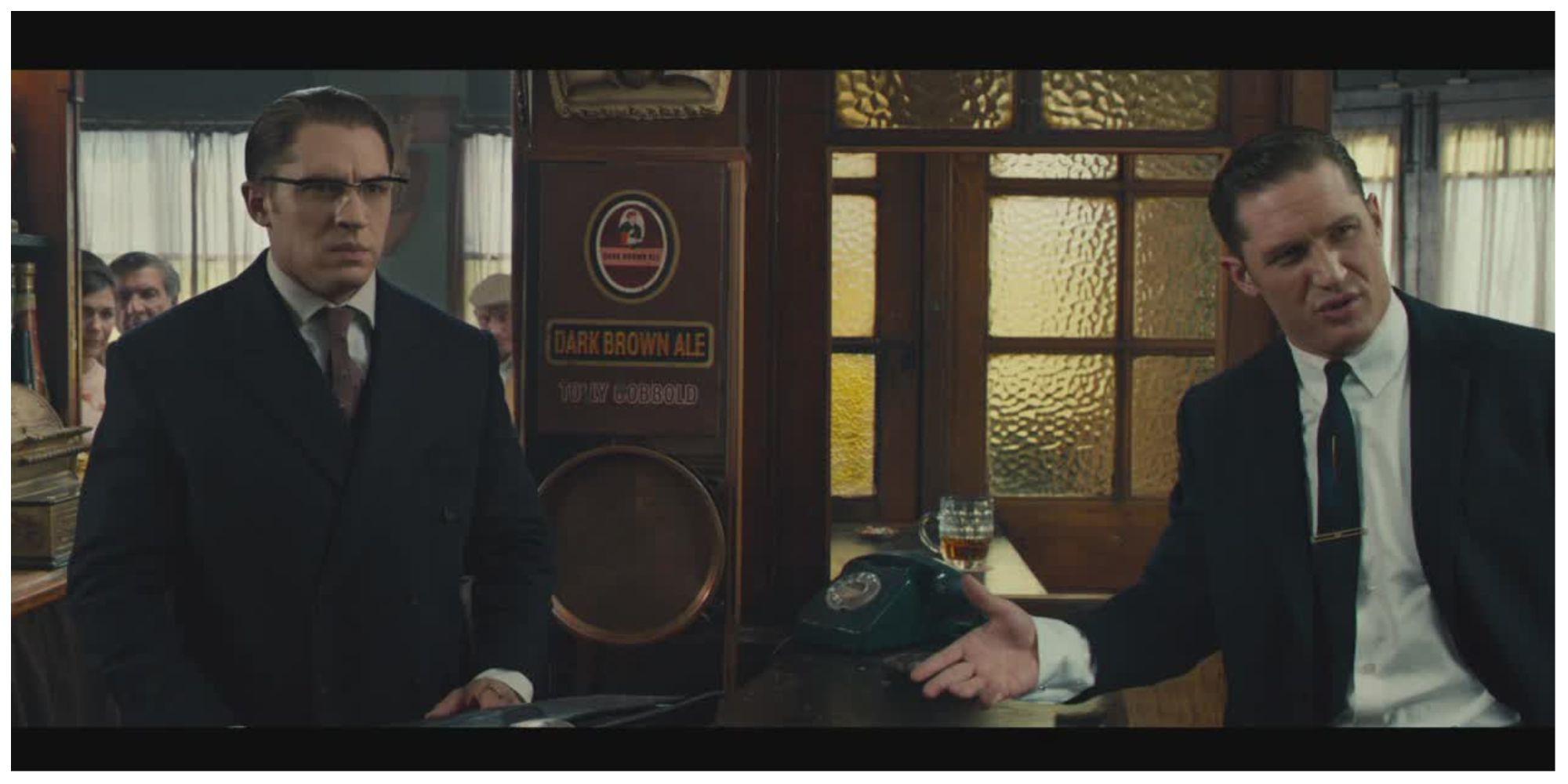 The Kray Twins stood in a pub in the Legend film having an intense conversation with someone off screen