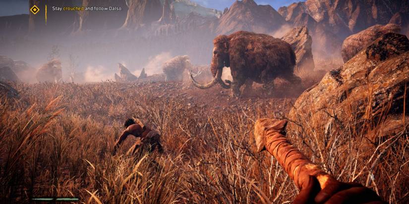 the player crouched with a mammoth in far cry primal