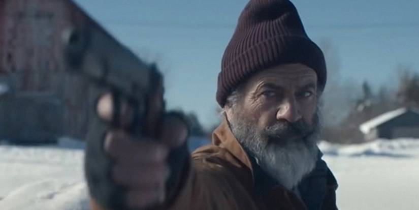 Mel Gibson as Santa Claus AKA Chris in Fatman, brandishing a gun