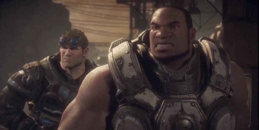 Cole Train standing at the forefront of a torn battleground with a grimace on his face, Dom in the background.