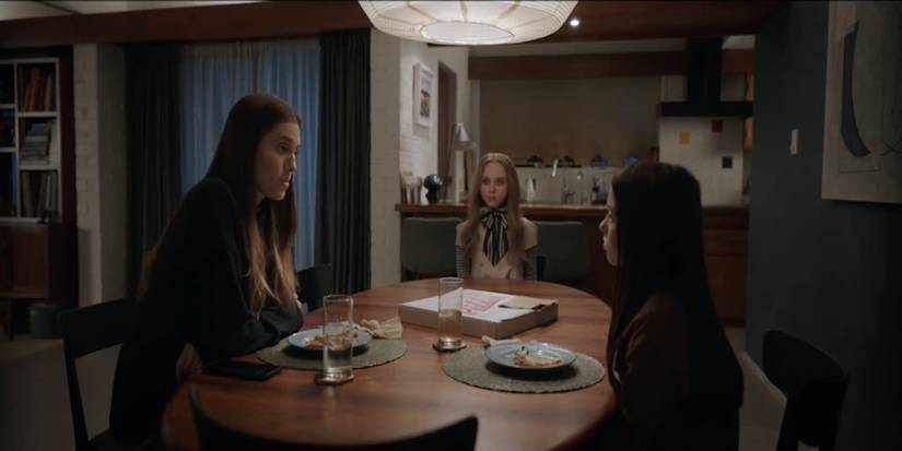 Gemma, M3GAN and Cady sitting at a table in M3GAN