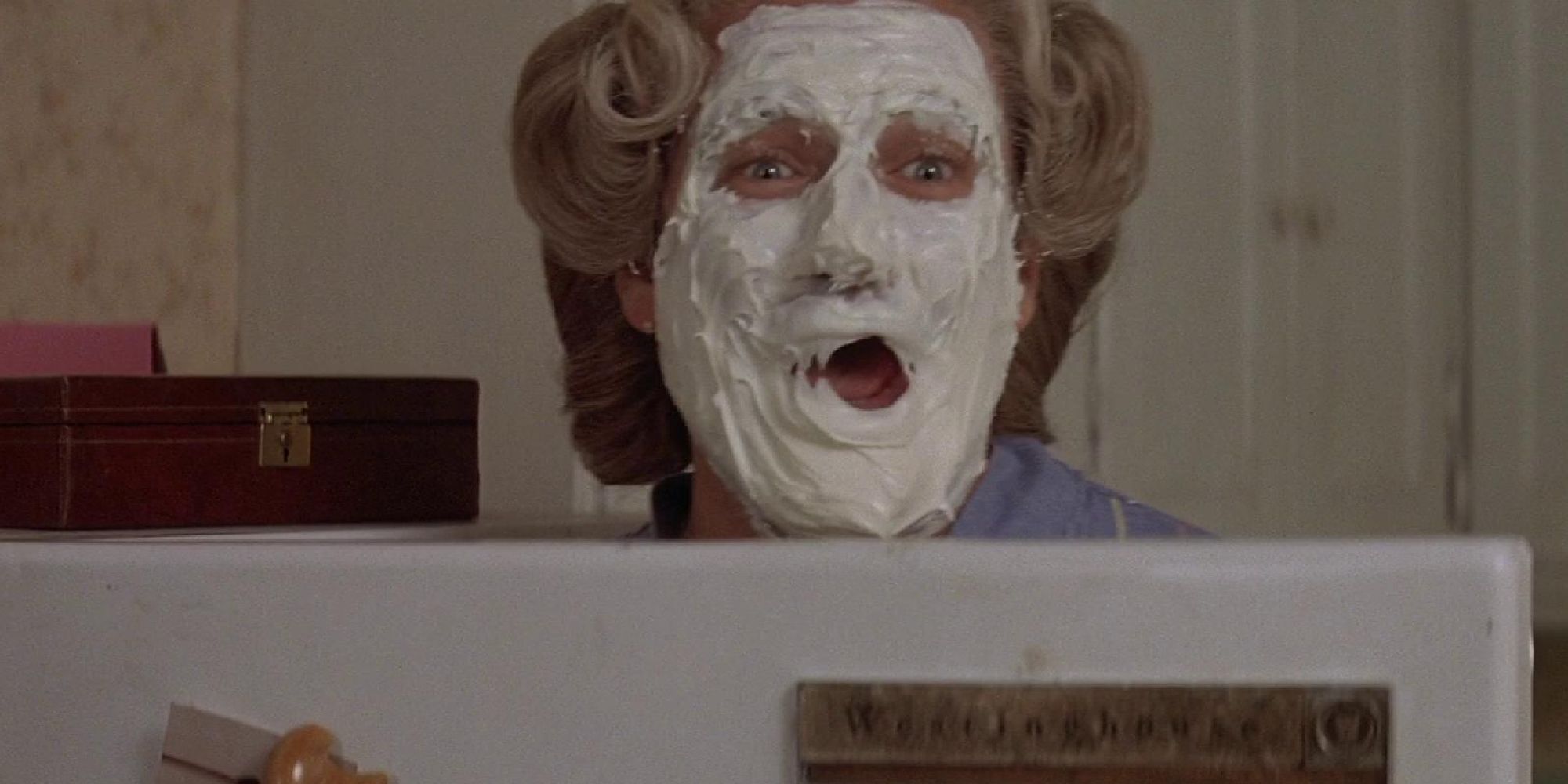 Robin Williams with pie covering his face in Mrs Doubtfire