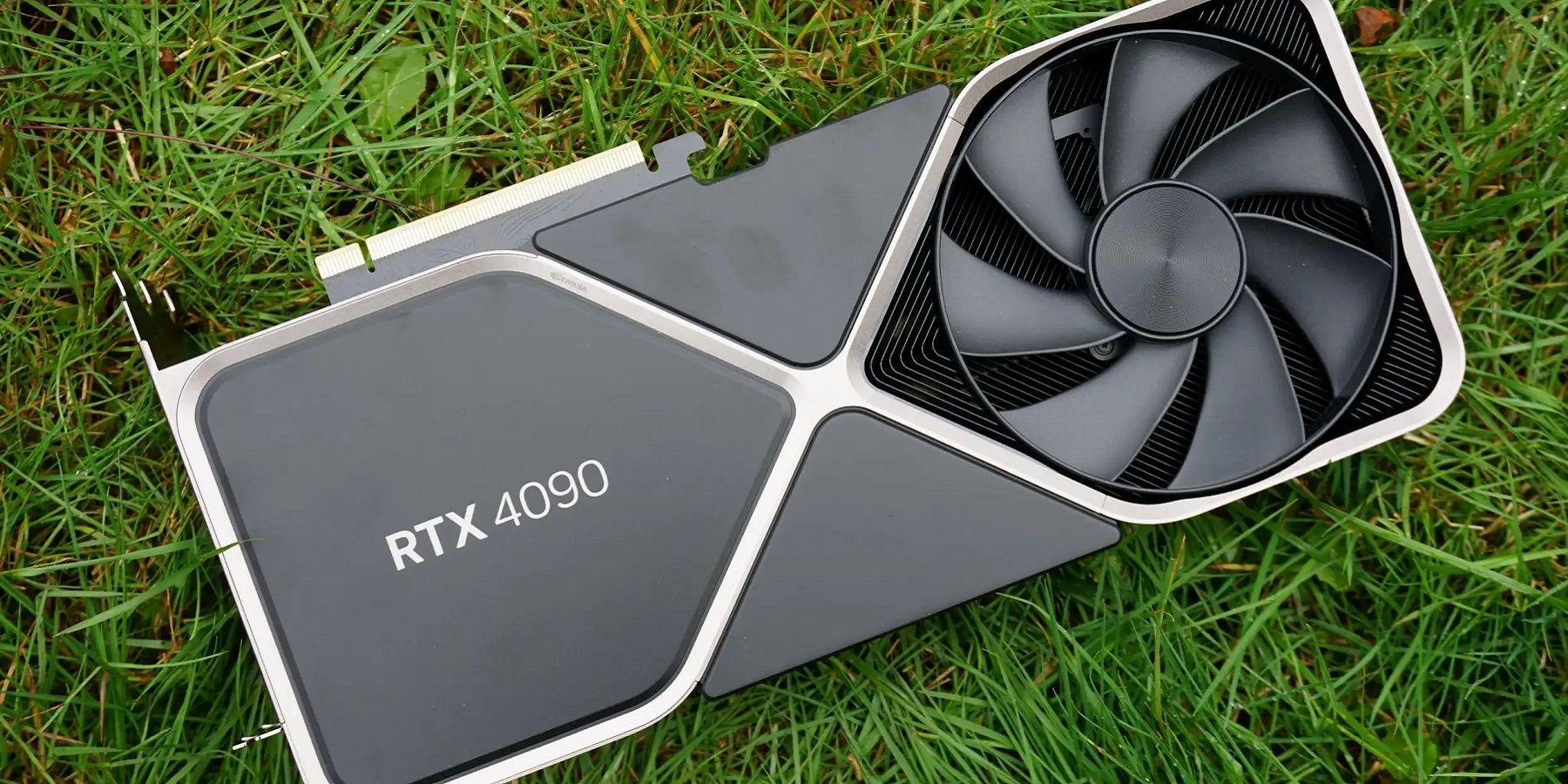 Photo of an Nvidia RTX 4090 graphics card on some grass.