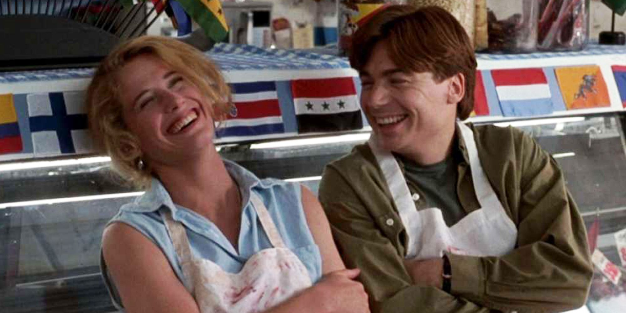 Mike Myers and Nancy Travis laughing in a butcher's shop