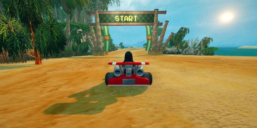 A penguin in a Formula One race car at the starting line of a race on a tropical beach. Image source: alternativeto.net