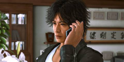 Takayuki Yagami taking a phone call in Lost Judgment