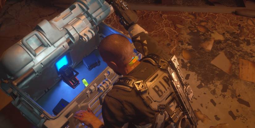 Jacob grabbing health items and resources from a supply crate in The Callisto Protocol