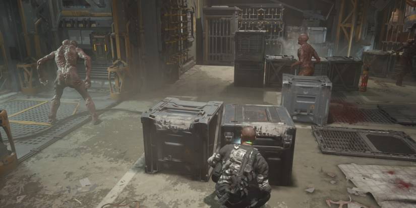 Jacob crouching behind boxes to avoid biophages in The Callisto Protocol