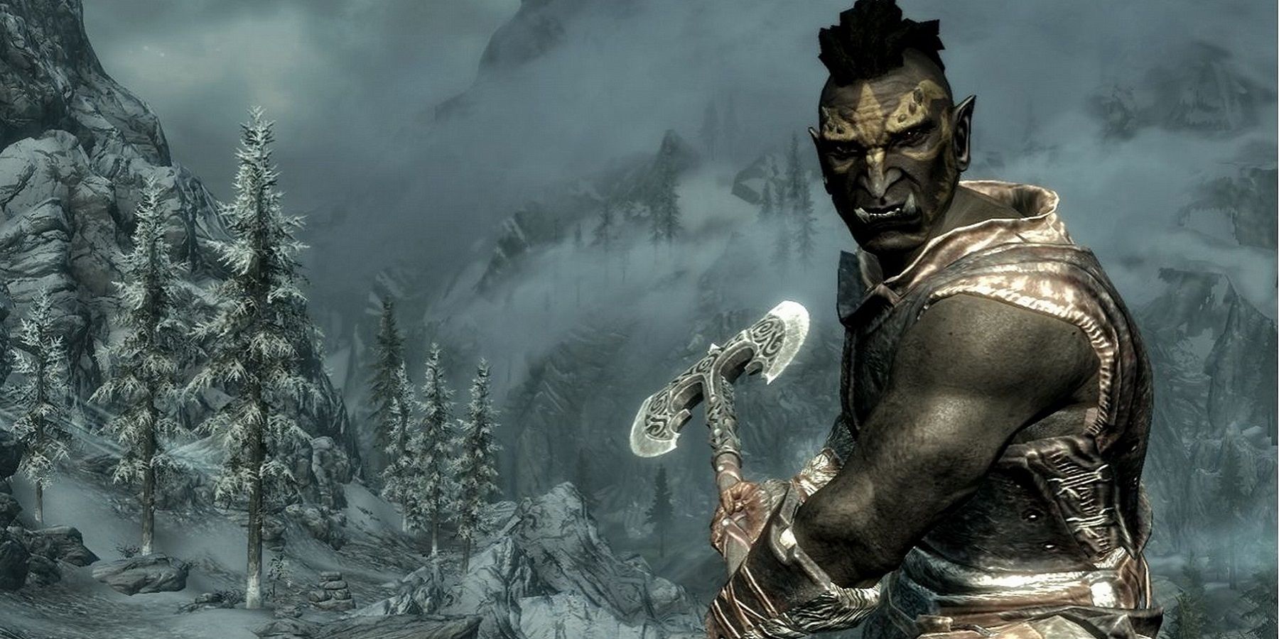 Image from Skyrim showing an Orc stood on a mountain whilst holding a two-handed axe.