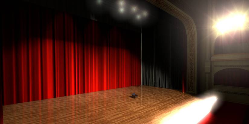 An empty stage with a single chair at the start of The Beginner's Guide