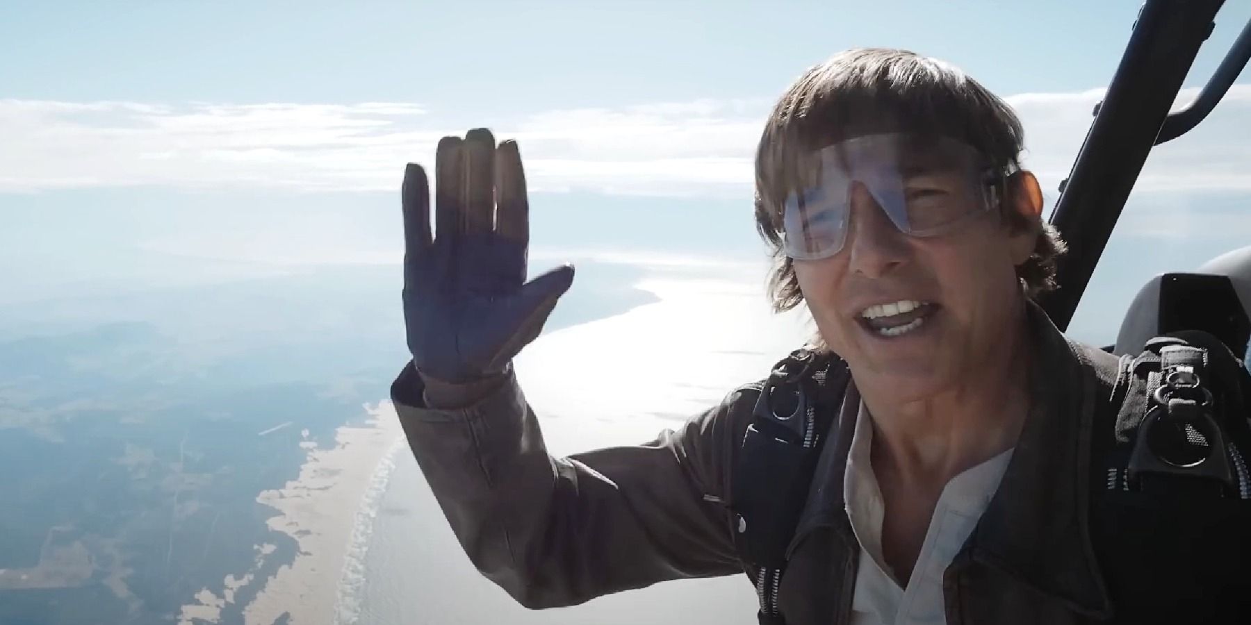 Tom Cruise waves before jumping off a plane in Mission Impossible Dead Reckoning set